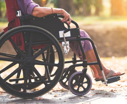 Woman sitting in black wheel chair