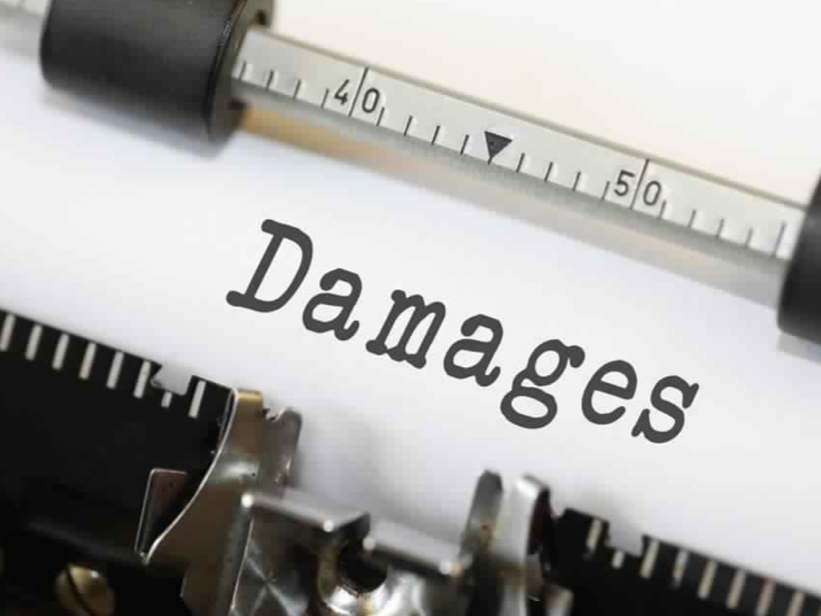 The word "Damages" typed on a piece of paper between various measuring tools